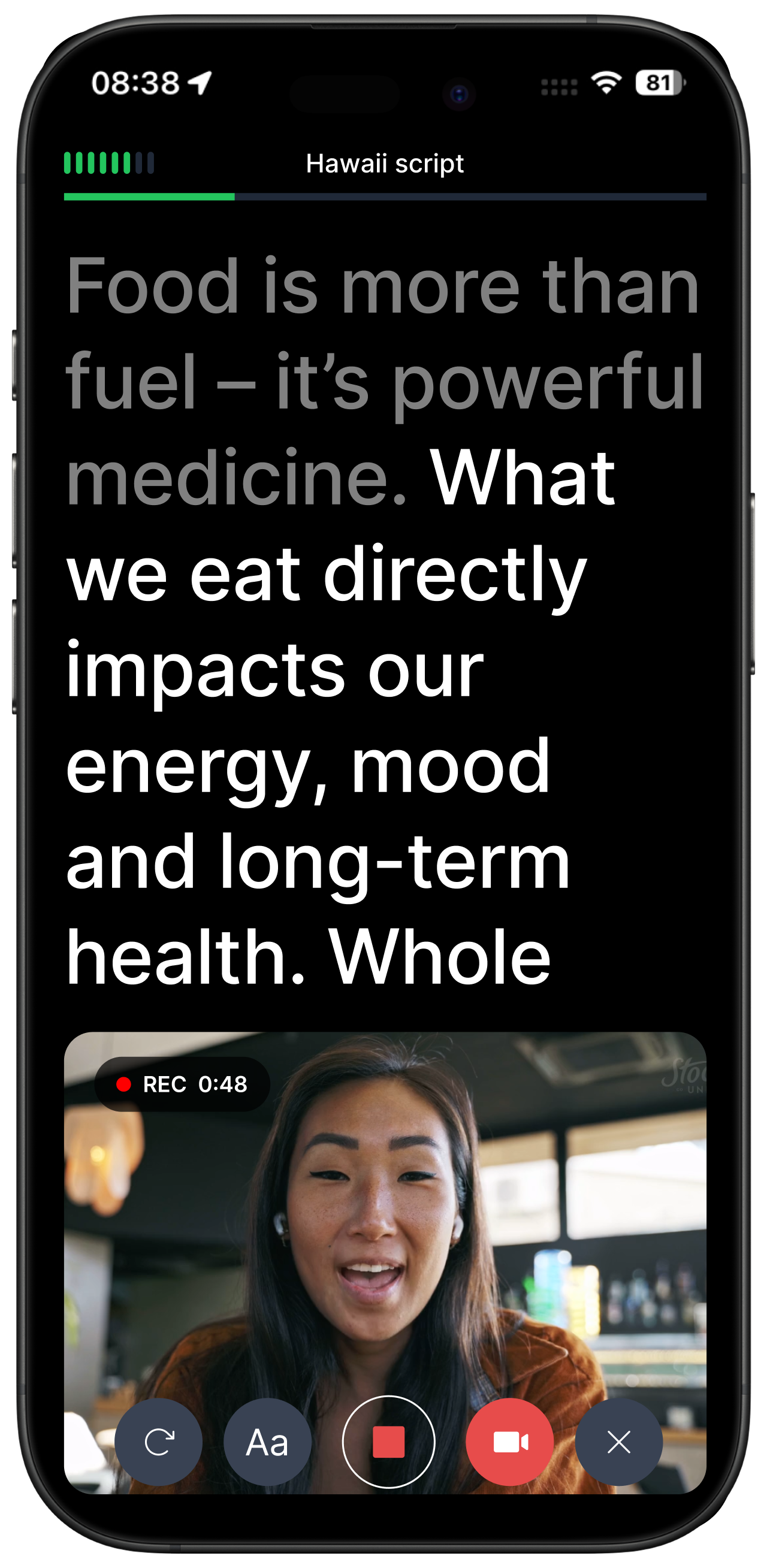 Hand holding iPhone showing teleprompting app interface